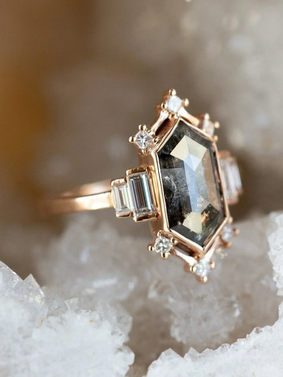 Gold ring with gemstones on a crystal background