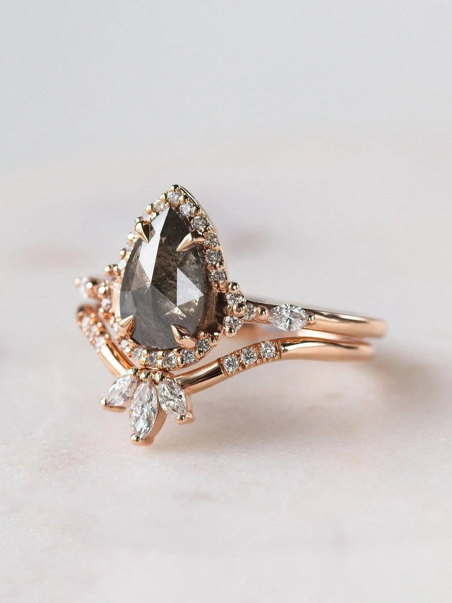 Pear-shaped salt and pepper diamond engagement ring in 14k rose gold  with matching band inspired by the art deco style and minimalism. 