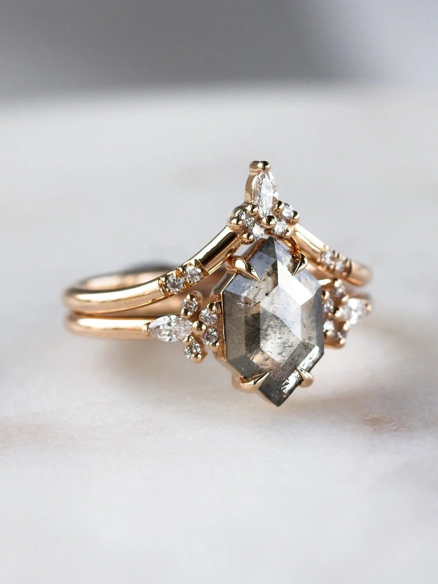 Gold ring with diamond accents on a light background