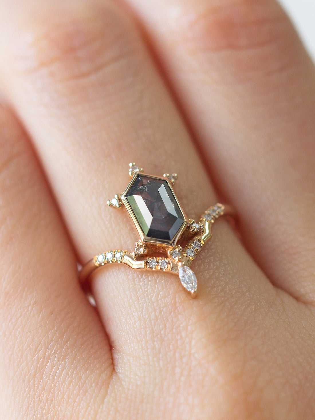 Unique art deco styled hexagon salt and pepper diamond engagement ring in 14k rose gold with a marquise and round diamonds on model&