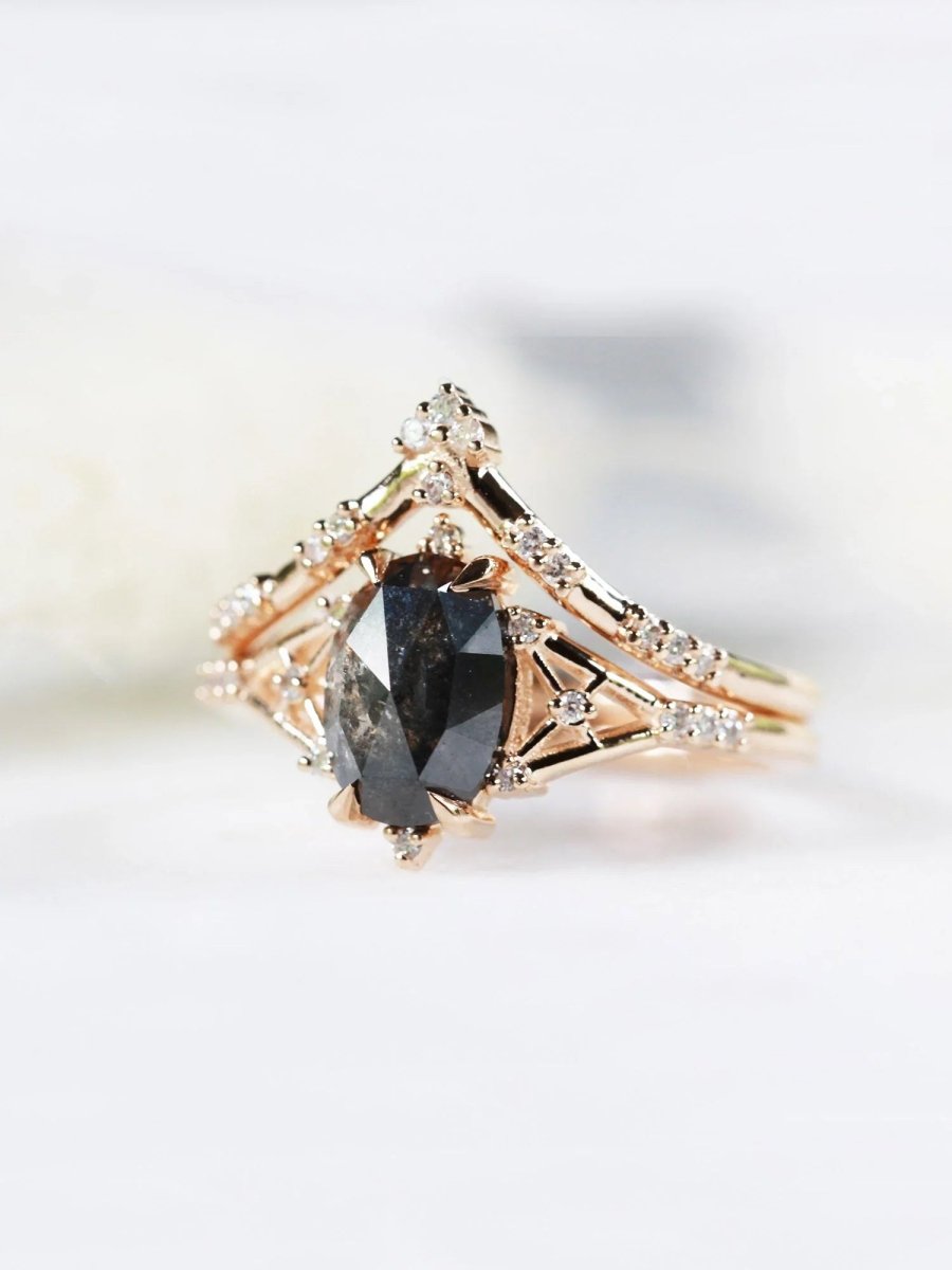 Art deco minimalistic oval salt and pepper diamond engagement ring in 14k rose gold with smaller round diamonds.