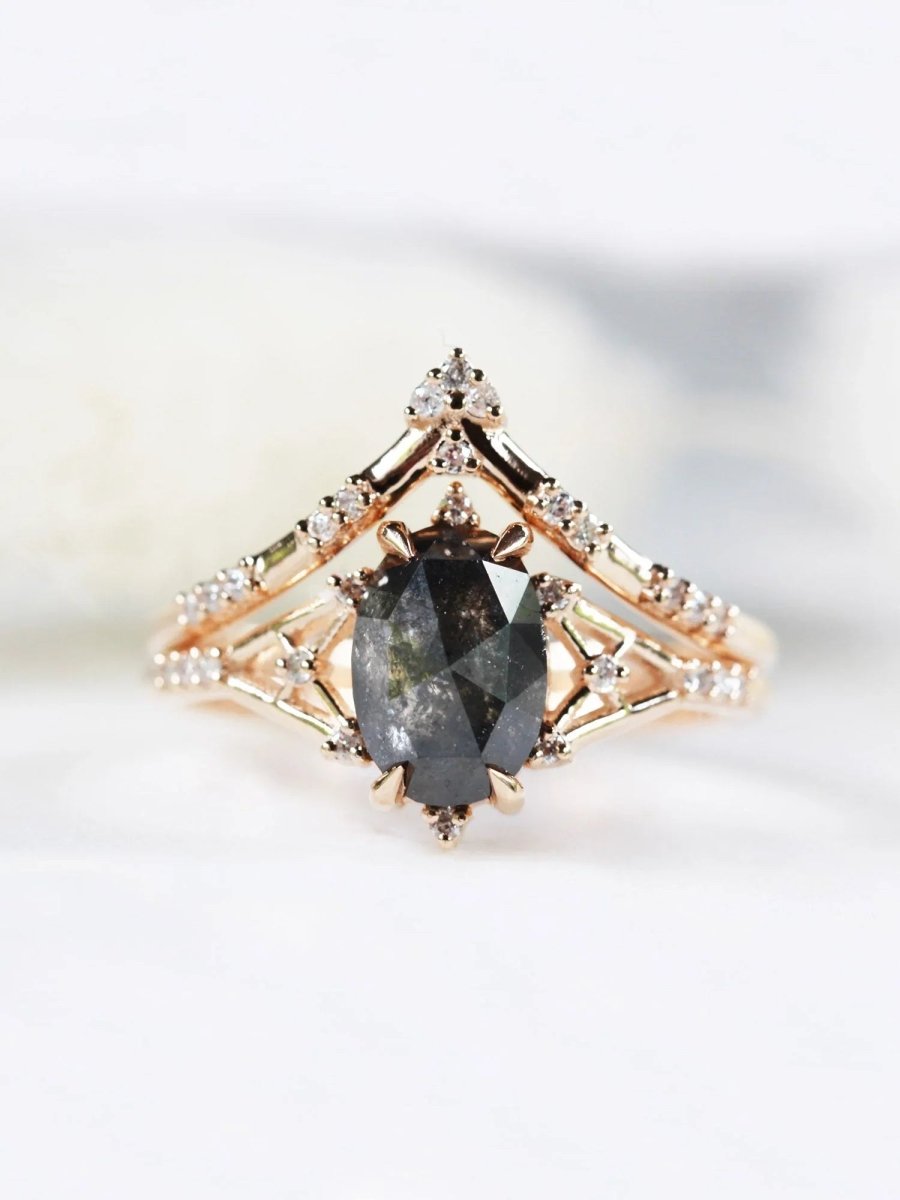 Art deco minimalistic oval salt and pepper diamond engagement ring in 14k rose gold with smaller round diamonds.