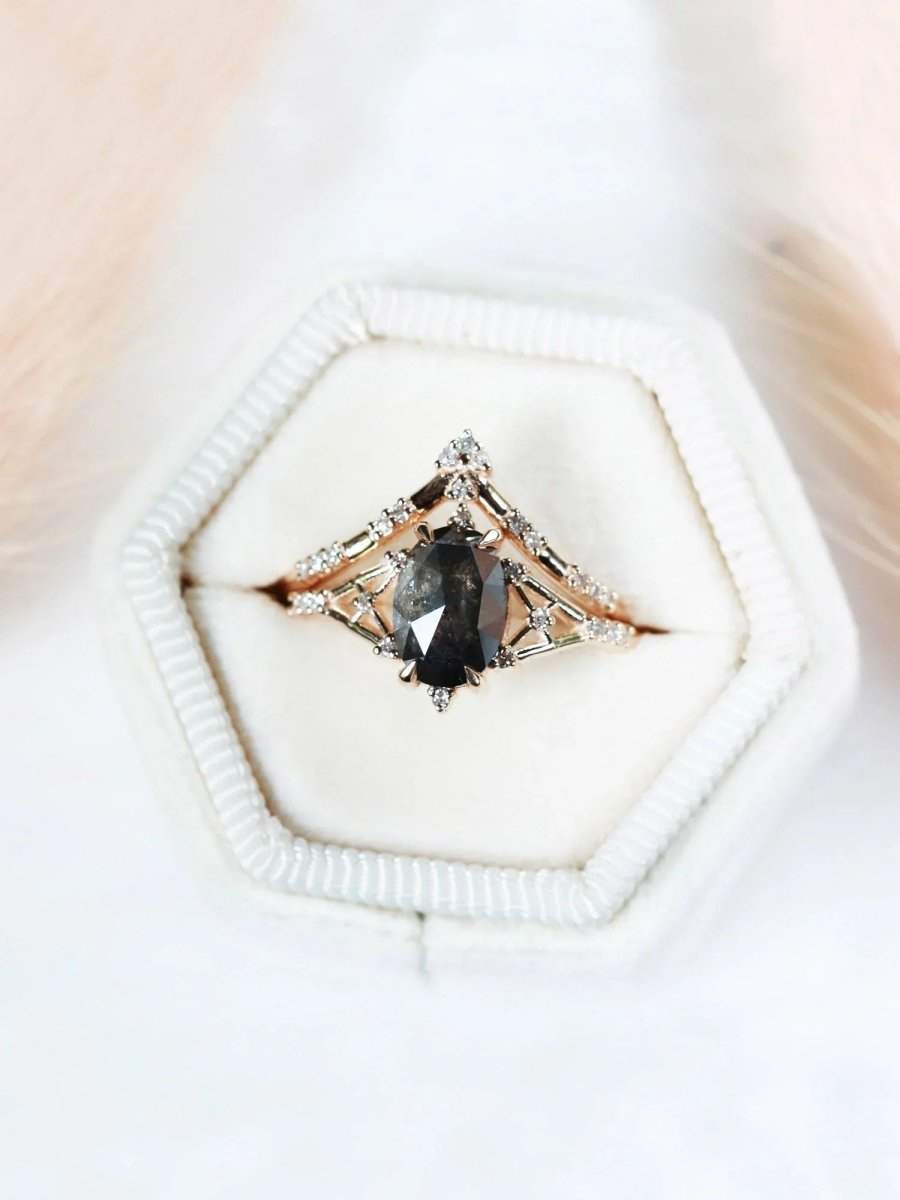 Art deco minimalistic oval salt and pepper diamond engagement ring in 14k rose gold with smaller round diamonds.