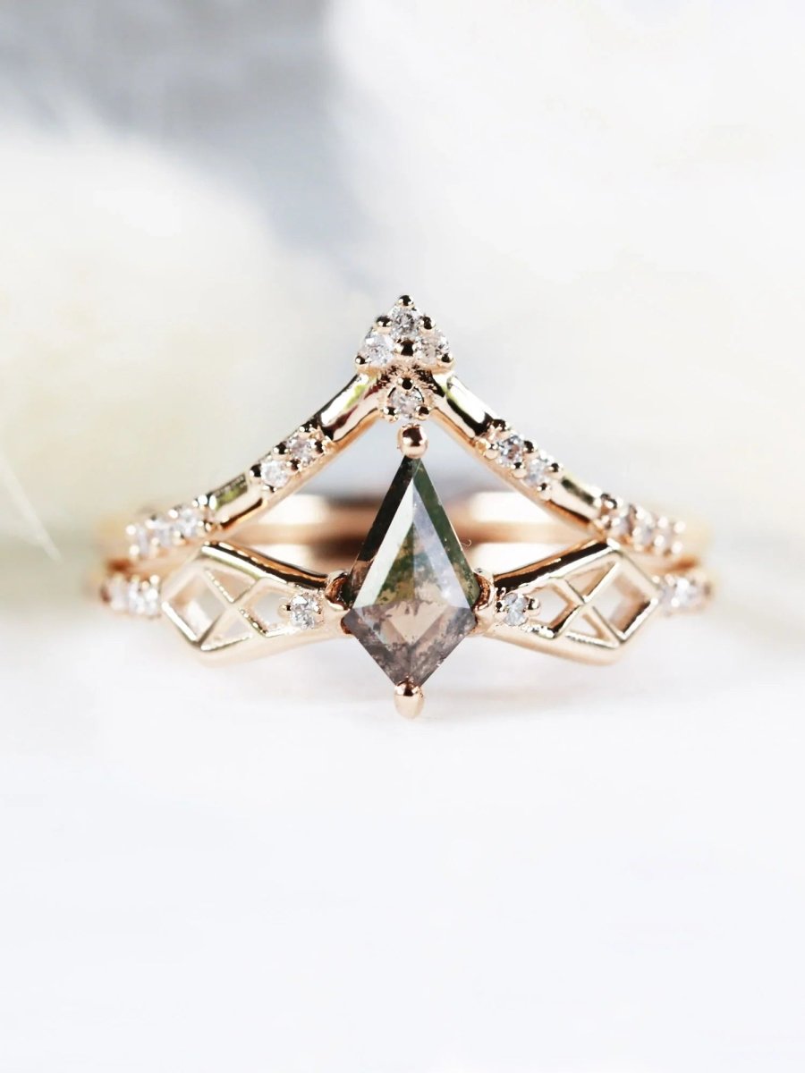 Face of modern Art Deco kite engagement ring with geometric latticed shoulders shaped like a bow, under matching chevron wedding band