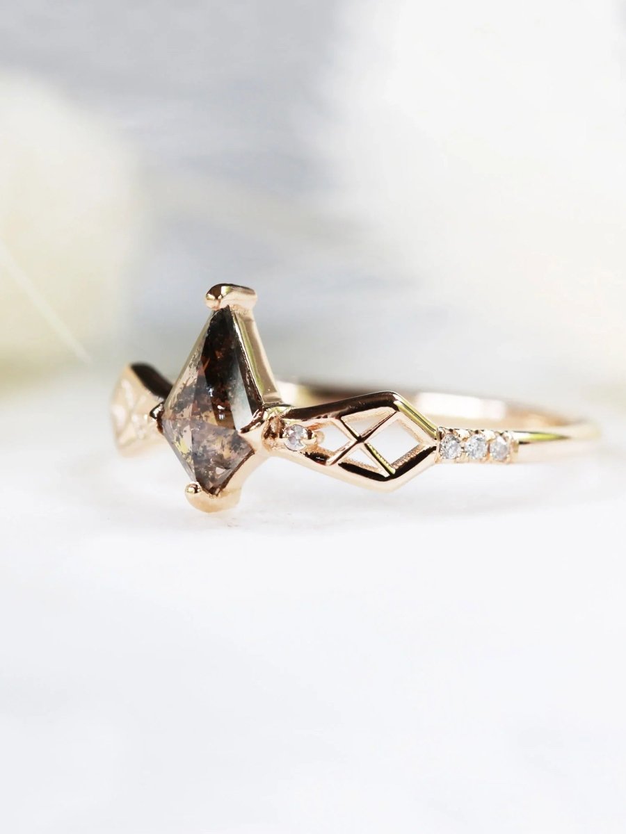 3/4 view of modern Art Deco salt & pepper kite engagement ring with geometric latticed shoulders shaped like a bow, against a soft white background