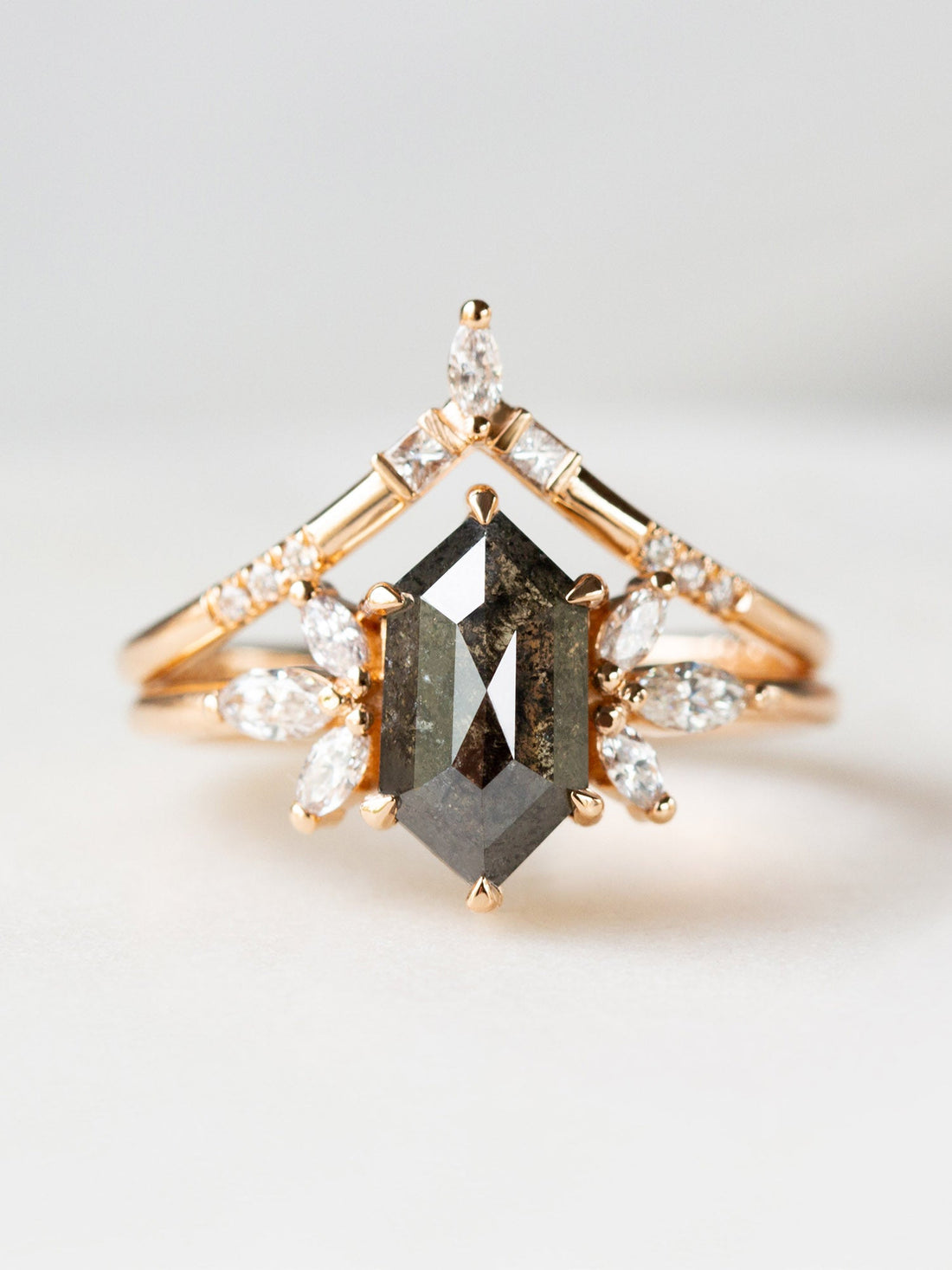 Art deco minimalistic hexagon salt and pepper diamond engagement ring in 14k rose gold with six smaller marquise diamonds with matching band.