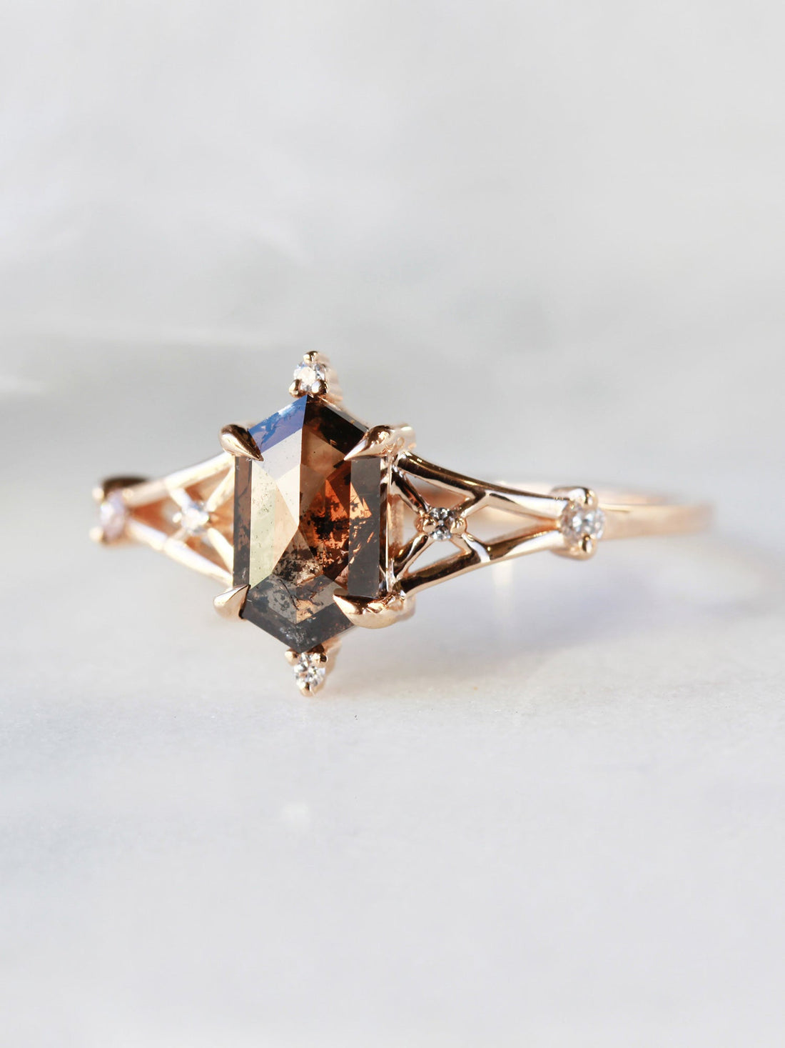 Hexagon salt and pepper diamond engagement ring in 14k rose gold with smaller and round diamonds inspired by the art deco style and minimalism.