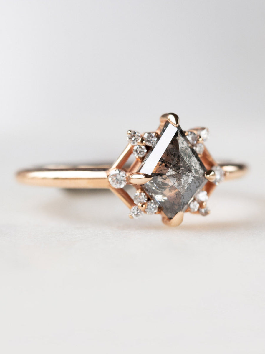 Delicate art deco style kite salt and pepper diamond engagement ring in 14k rose gold with smaller round diamonds.