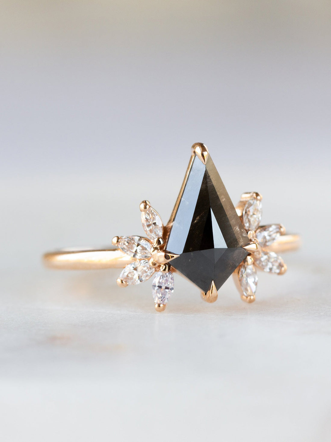 Kite salt and pepper diamond engagement ring in 14k rose gold with four marquise arrangements on each side inspired by the art deco style and minimalism. 