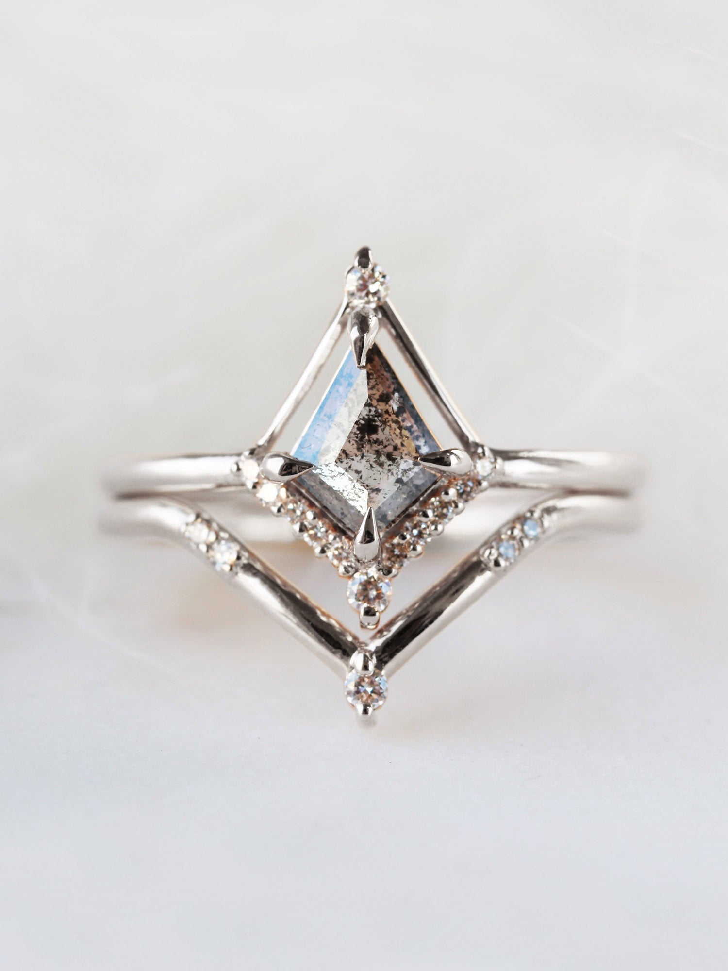 Kite shape salt and pepper diamond engagement ring with smaller round diamonds in 14k gold inspired by the art deco style and minimalism.