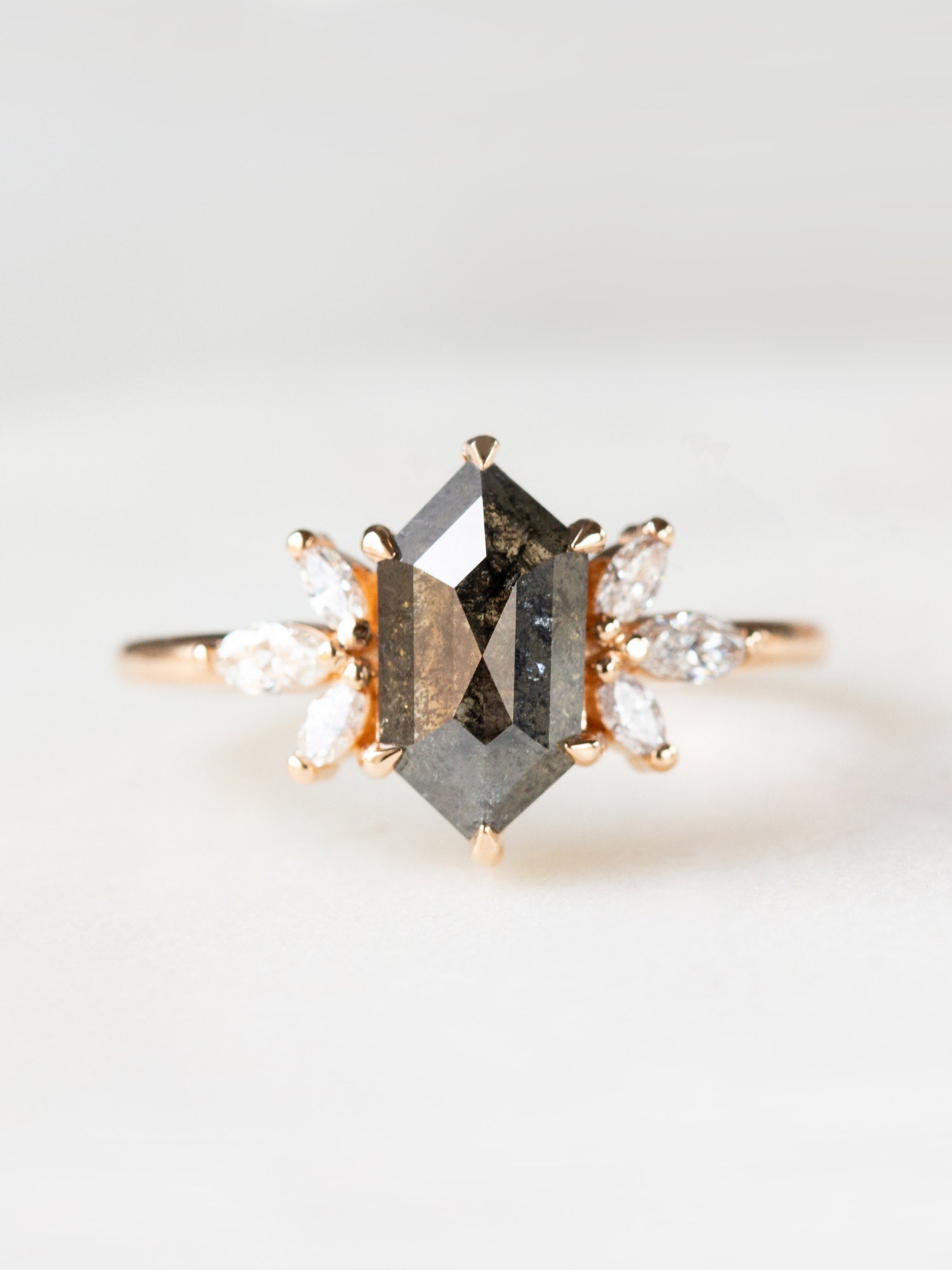 Art deco minimalistic hexagon salt and pepper diamond engagement ring in 14k rose gold with six smaller marquise diamonds.