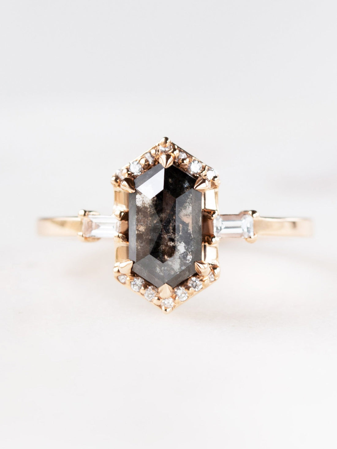 Unique art deco styled hexagon salt and pepper diamond engagement ring in 14k rose gold with baguette and round diamonds.