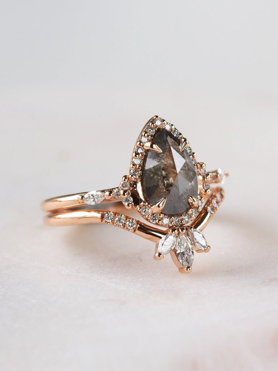 Pear-shaped salt and pepper diamond engagement ring in 14k rose gold  with matching band inspired by the art deco style and minimalism. 
