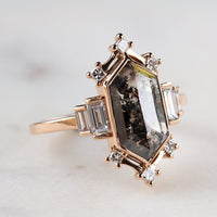 Minimalistic and art deco styled hexagon salt and pepper diamond engagement ring in 14k rose gold with princess and baguette diamonds.