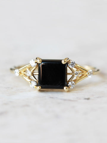 Minimal modern art deco style unique rectangle Onyx engagement ring in 14k gold with smaller round diamonds.