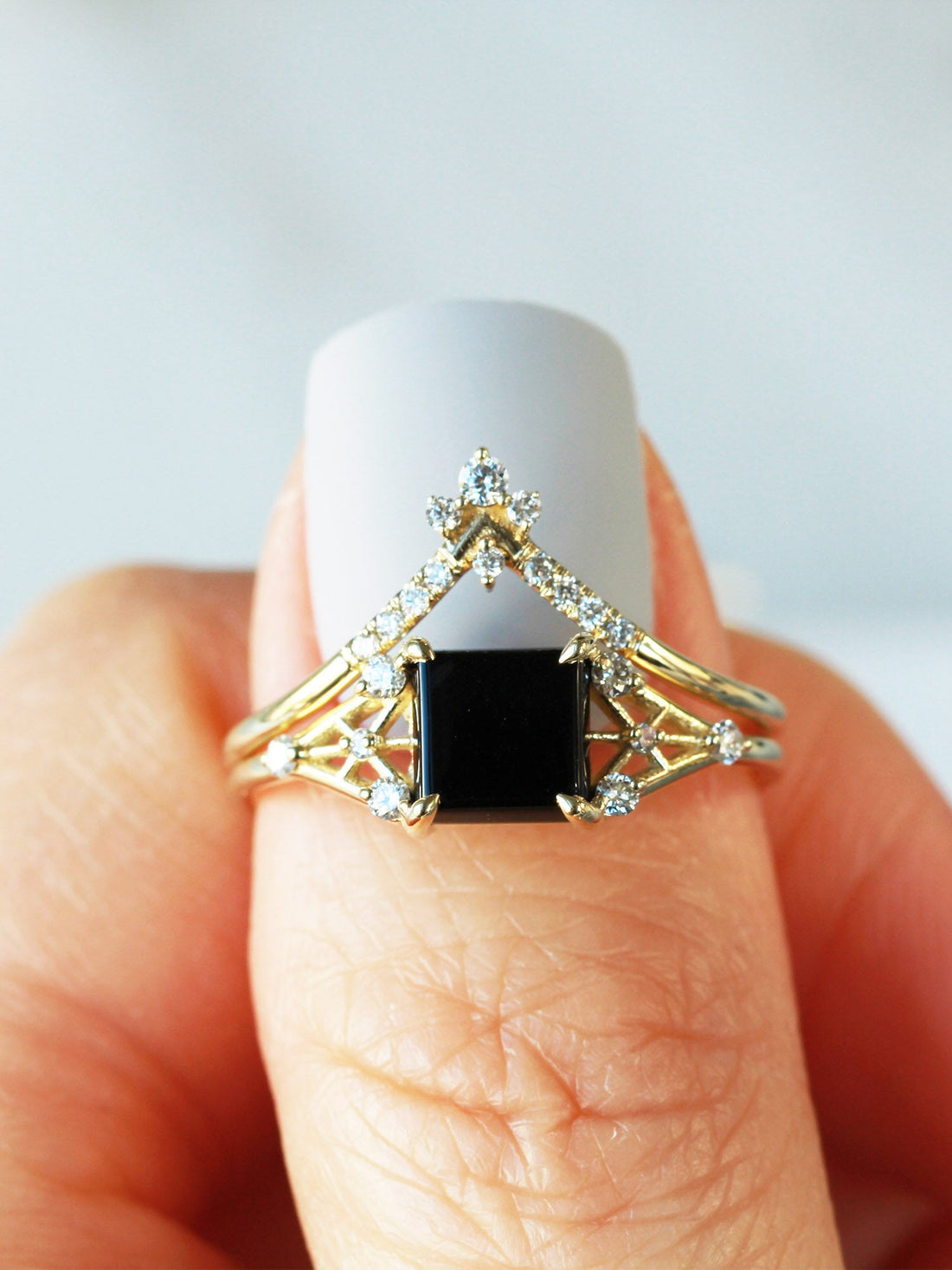 Minimal modern art deco style unique rectangle Onyx engagement ring in 14k gold with smaller round diamonds on model&