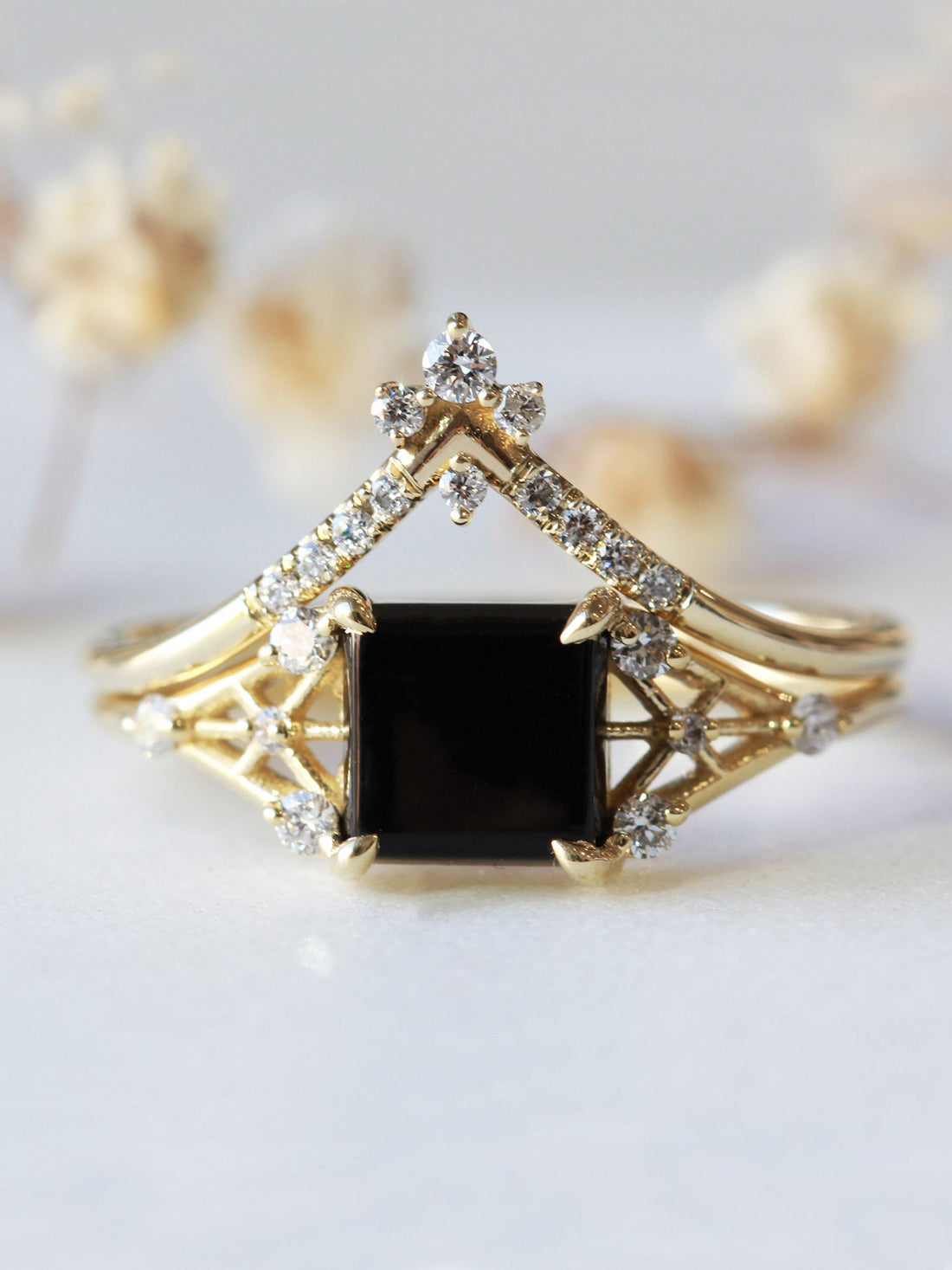 Minimal modern art deco style unique rectangle Onyx engagement ring in 14k gold with smaller round diamonds.