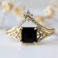 Minimal modern art deco style unique rectangle Onyx engagement ring in 14k gold with smaller round diamonds.