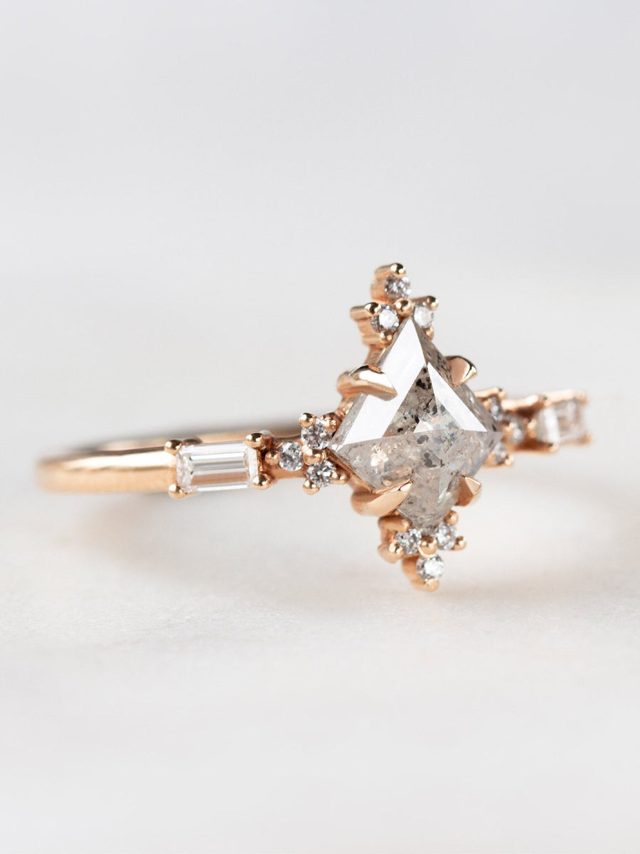 Art deco style minimal kite shape salt and pepper diamond engagement ring in 14k rose gold with smaller baguette and round diamonds.